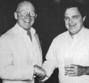 Brian Zevnik (right) passes the reins to Charlie Stephens and helps himself to a cold one